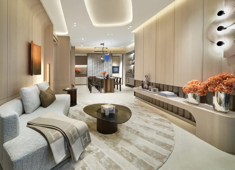 Union Square Residences, for illustration only: living room interior with a curved sofa, timber feature wall and dining area beyond